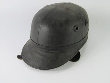 A vintage leather motorcycle helmet or scull cap.