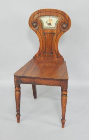 A George IV mahogany hall chair with painted crest to the carved back