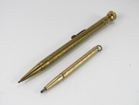 Two gold plated propelling pencils.