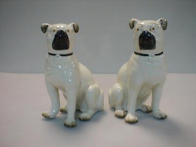 A pair of Staffordshire pottery pug dogs