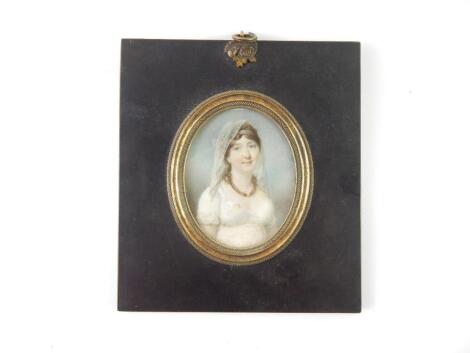 English School (early 19thC). Half length portrait of a lady in a white dress and veil