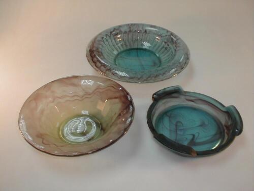 A blue cloud glass bowl and stand and an amber cloud glass bowl
