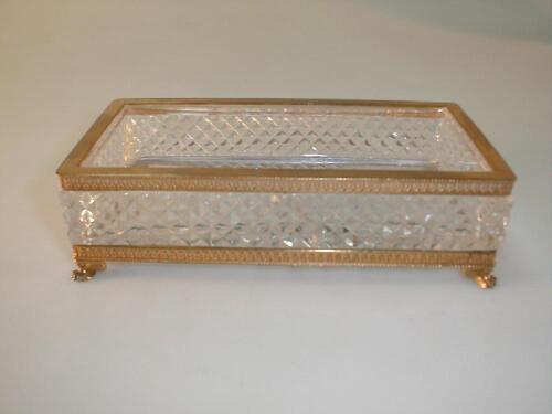 A heavy glass pen tray with star cut base