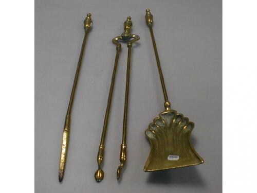 A Victorian brass three piece companion set with urn handles