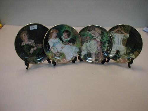 Four collectors plates showing pears advertisements