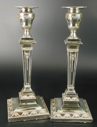 A pair of late Victorian silver Neo-Classical style candlesticks