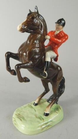 A Beswick model of a huntsman and horse and rearing horse