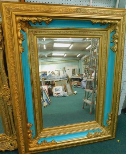 A modern gilt and turquoise painted wall mirror