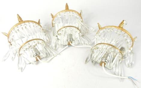 A set of three gilt metal wall lights