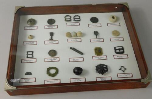 A framed collection of various archaeological finds