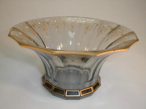 A smoked glass dish, of panelled circular form with a swept rim, the rim