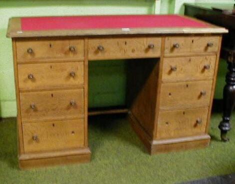 A Victorian oak kneehole desk