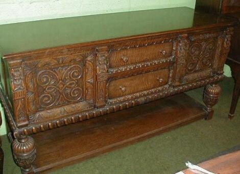 A heavy oak carved sideboard or buffet in the Jacobean style