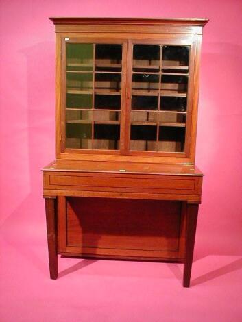 A 19thC ebony strung mahogany writing cabinet with two door glazed bookcase top