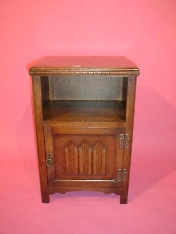 A linen fold oak pot cupboard