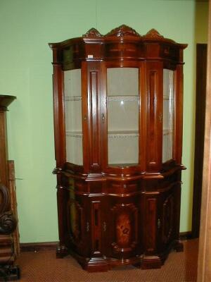 A reproduction walnut marquetry serpentine cabinet