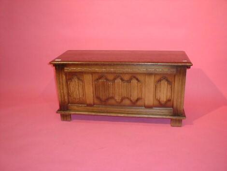 A linen fold oak reproduction coffer