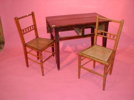 A 19thC elm table and two chairs