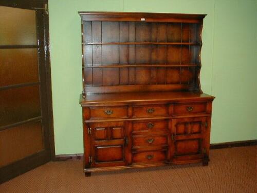 An oak Batheaston, Cumper and Lockhart dresser with plate rack