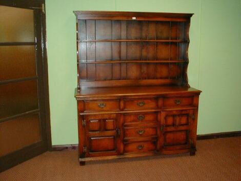 An oak Batheaston, Cumper and Lockhart dresser with plate rack