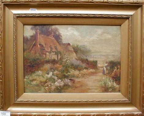 A gilt framed cottage scene with floral gardens and figure