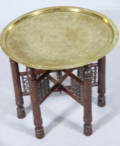 An Eastern brass topped table