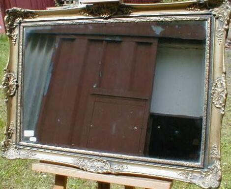 A modern and gilt framed wall mirror