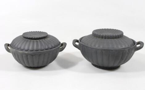 A graduated pair of 19thC basalt jars and covers