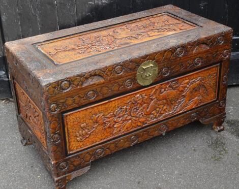 A heavily carved early 20thC camphor wood chest