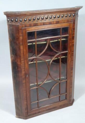 An 18thC mahogany hanging corner cupboard