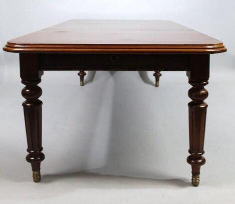 A Victorian mahogany wind out dining table