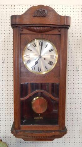 An early 20thC oak cased wall clock