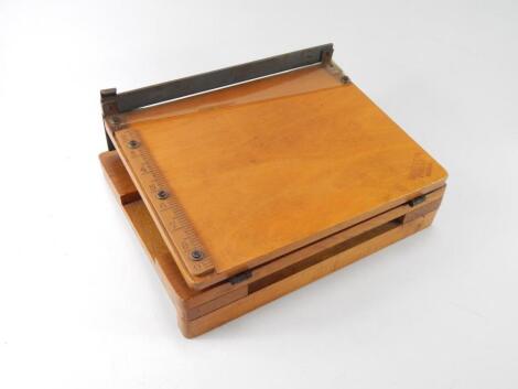 A Merretts patent wooden table top paper guillotine