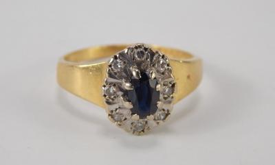 An 18ct gold and sapphire oval cluster ring