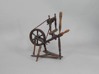 A 19thC turned wood country made spinning wheel