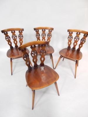 A set of four Ercol oak single dining chairs