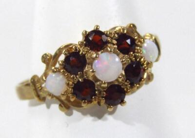 A ladies 9ct gold opal and garnet dress ring