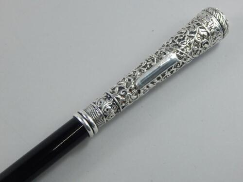 A Continental white metal and black lacquered walking cane
