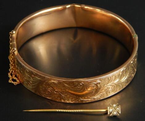 A 9ct gold bangle and a stick pin