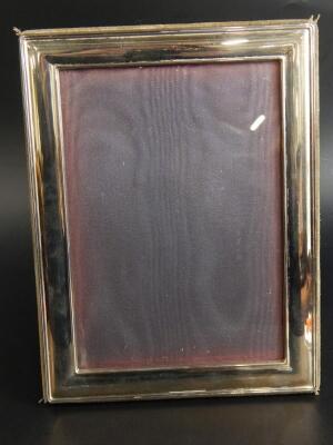 A modern silver plated rectangular photograph frame