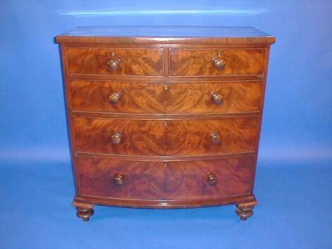 A Victorian flamed mahogany bow front chest of two short and three long