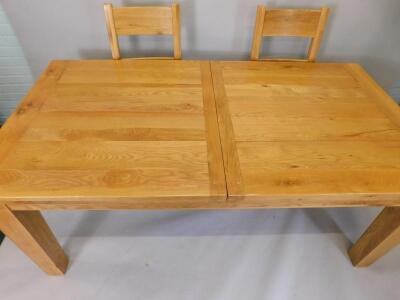 A large modern light oak extending dining table - 2