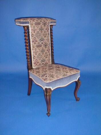 A Victorian rose wood prie-dieu chair with barley twist supports and tapestry upholstery