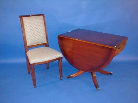 A reproduction mahogany drop leaf table and an upholstered side chair