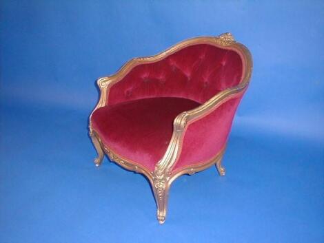 A Louis XV style child's chair with gilt wood frame and deep button draylon upholstery