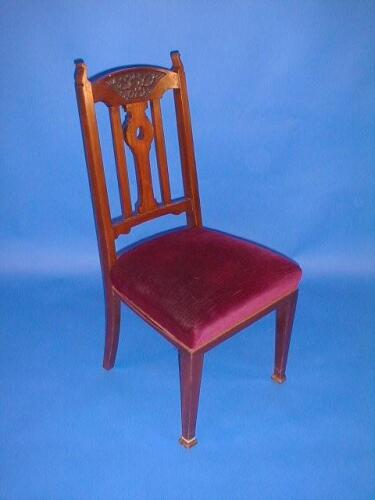 A set of four Art Nouveau walnut high back dining chairs