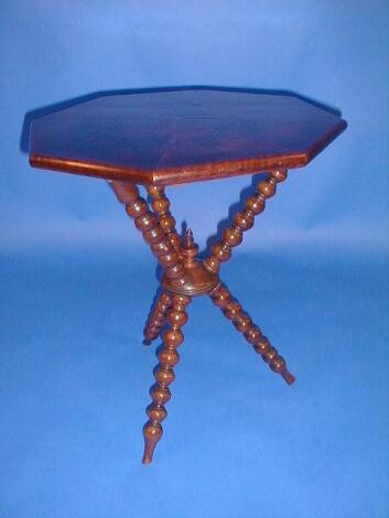 A Victorian gypsy table with walnut veneered octagonal top and turned cap stand base