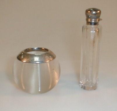 A match striker with silver collar together with a small silver topped perfume bottle