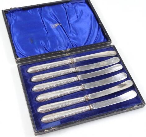 A set of silver handled butter knives