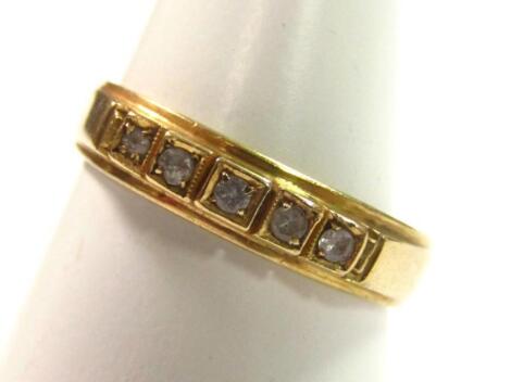 A five stone half eternity ring